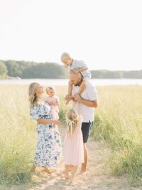 large extended family session with blue, green and peach colors on beach in wells maine by carrie pellerin