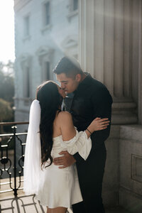 A bride and groom share a kiss during their sunset elopement at the top of the South Carolina State House.