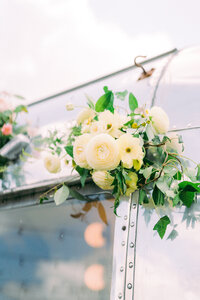 White flower instillation for the side of a vehicle at a wedding