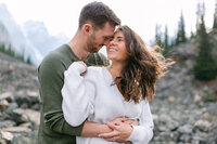 This touching photograph showcases a couple from their engagement shoot at Moraine Lake, praising Geoff Wilkings Photography. They commend Geoff’s expertise in capturing the stunning scenery and their genuine connection, turning the breathtaking backdrop of Moraine Lake into timeless images they will treasure forever.