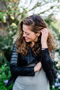 A woman tucking her hair behind her ear while near Seattle.