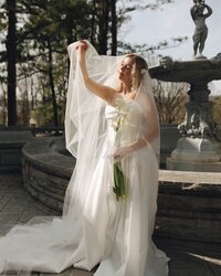 Bride's portrait captured elegantly by the venue's fountain