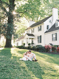 Couple during an estate engagement session surrounded by lush gardens and elegant architecture, captured by a destination wedding photographer in DC and Seattle

