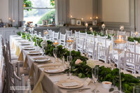 Long estate table with greenery and candles