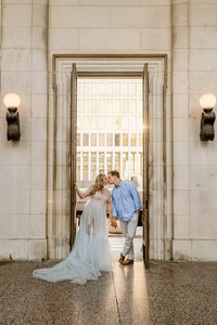 newlyweds kiss in door frame