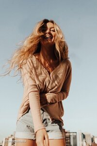 Candid image of girls laughing together during golden hour, conveying joyful vibes.