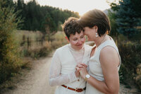 A couple holds hands and embraces at their intimate wedding planned by Boise wedding planner Perfect Thirds & Co. 