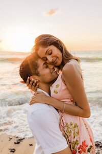 couple cuddling at sunset after their maui proposal