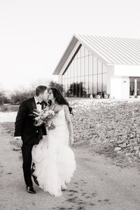 Bride walking across venue with groom at Desert View Weddings.