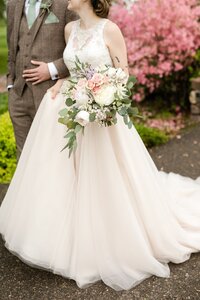Woman straitening grooms bow tie