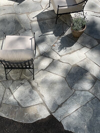 Flagstone patio with outdoor wrought iron club chairs - Nadine Stay
