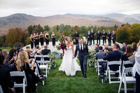 bride and groom walking down the aisle in vermont