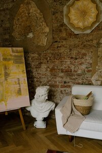 sculpture bust on the floor with a canvas