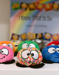Colorful therapy plush toys lined up on a table