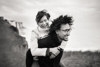 A couple playing on a cliff