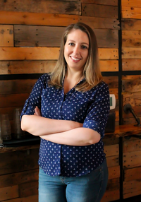 Virtual assistant client wearing blue polka dot shirt against wooden background