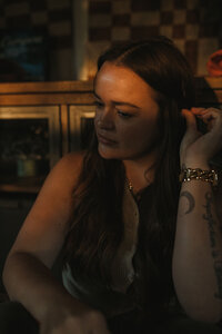 Paige Rini photographed in-home with moody lighting during a branding session