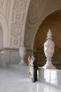 Bride and groom kiss on their wedding day at San Francisco City Hall