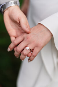 Close-up of bride’s hand showing her engagement ring, emphasizing the intricate design