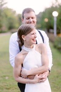 Happy candid photo of a bride and groom hugging