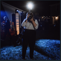 Kristen Catoe, a philadelphia-based wedding photographer, takes a picture with flash in a dark environment