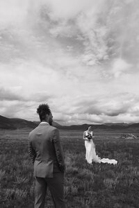 bride and groom posing on a bridge