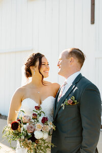 groom hugging bride from behind