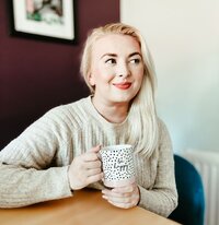 copywriter aoibh smiling with coffee