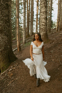 girl standing in woodland area for senior portrait