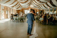 Bride and groom hugging while dancing during their reception