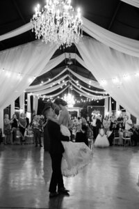 Couples first dance under elegant chandelier