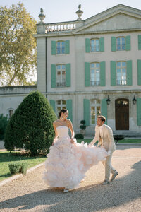 Bride walking along cypress-lined path at an elegant destination wedding in Tuscany, photographed by Michigan wedding photographer Raechel Marie.