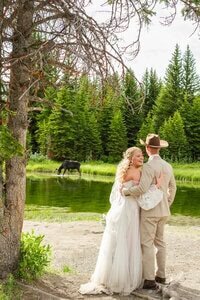 Couple elopes with Moose in background at Swabacher's Landing