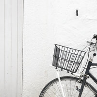Black bike with basket on white background