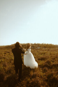 Bride and groom eloping on the Oregon Coast at Cannon Beach, with Haystack Rock in the background.