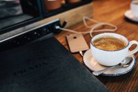 Coffee in a white cup on wooded table