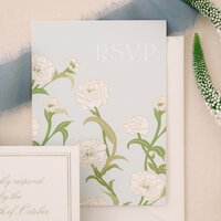 Watercolor chinoiserie pattern with peacocks, an oval gold wax seal with monogram. Vellum wrap with a letterpressed wedding invitation