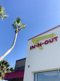 View from below of the In-N-Out logo on the side of a building