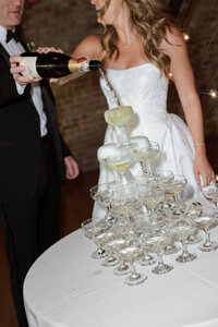 Close up of a hand opening a bottle of champagne