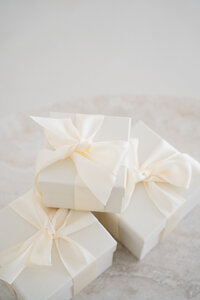 Stack of small boxes with large cream ribbon
