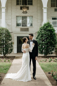 Wedding portraits of the bride and groom with her veil and florals