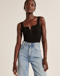 woman modeling a black bodysuit and jeans