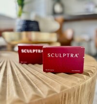 Box of Sculptra sitting on a wood table