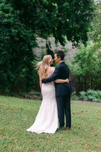 Newlyweds celebrating across the road from the Brisbane Registry Office at King Edward Park, surrounded by greenery.