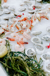 Shrimp and oysters sitting on a wedding reception table 
