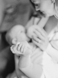 Mother feeding baby Denver Family Newborn Photographer