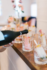 Champagne being poured into cocktail glasses at Refine for Wedding Planners Retreat