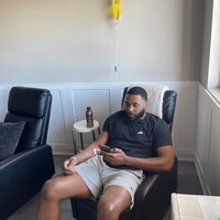 Man receiving an IV injection in the lounge