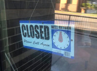 Closed sign on a glass door