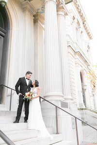 Maryland Wedding Photographer snaps a photo of a couple outside the Peabody Library in Mount Vernon Baltimore Maryland 